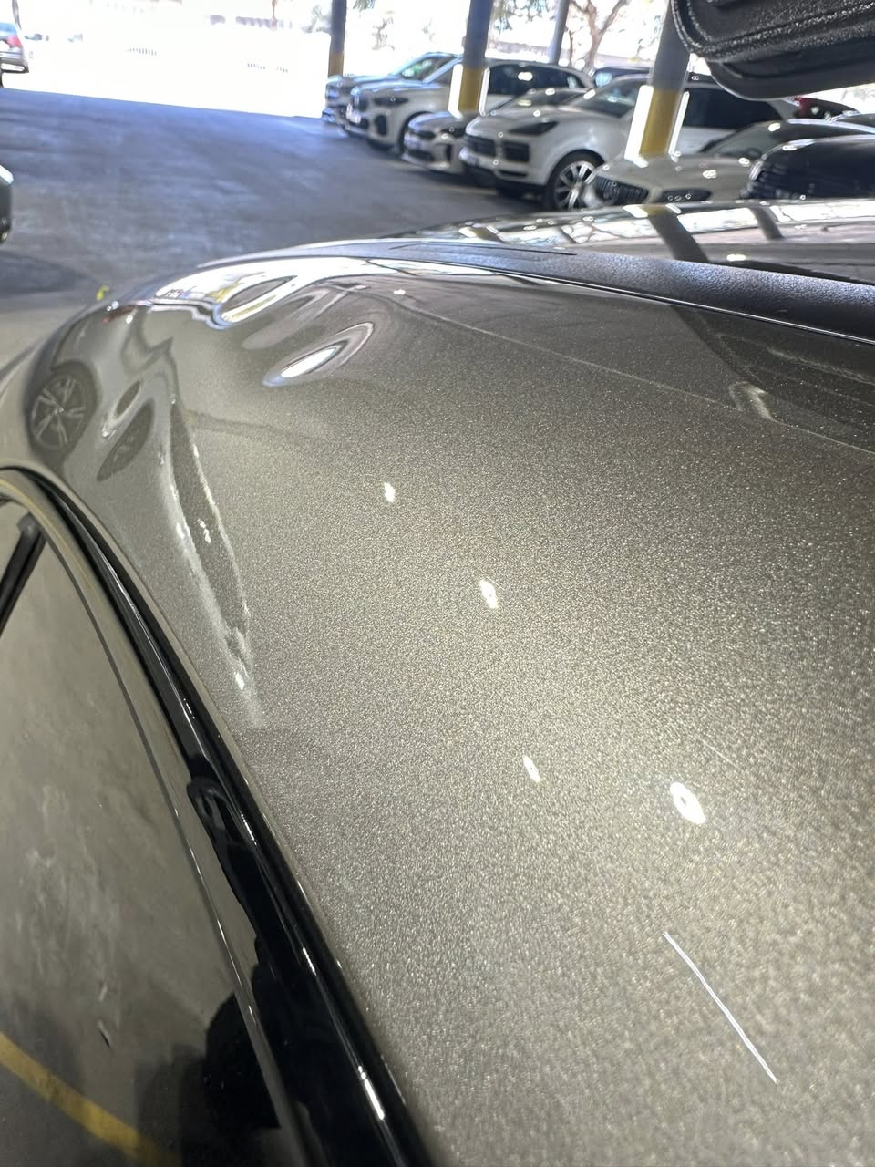 Hail damage on car roof — multiple dents visible
