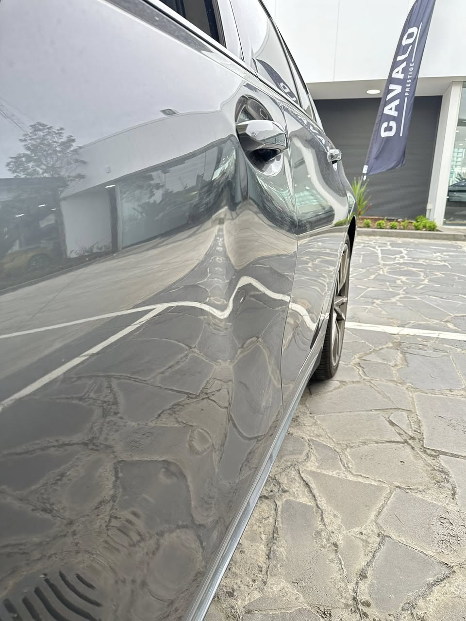Prestige vehicle door dent before paintless dent removal