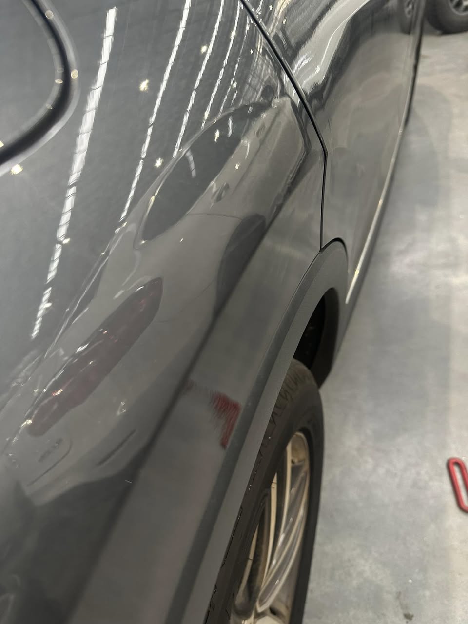 Quarter panel after paintless dent removal — flawless result